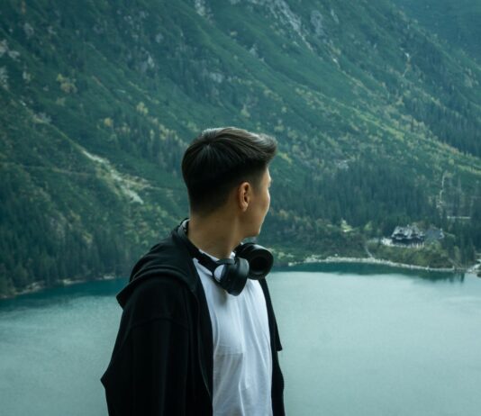 Mężczyzna podziwia Morskie Oko otoczone las